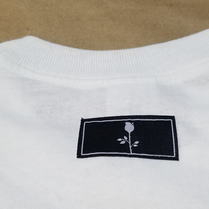 image of woven label sewn into the back of the neck of a t shirt